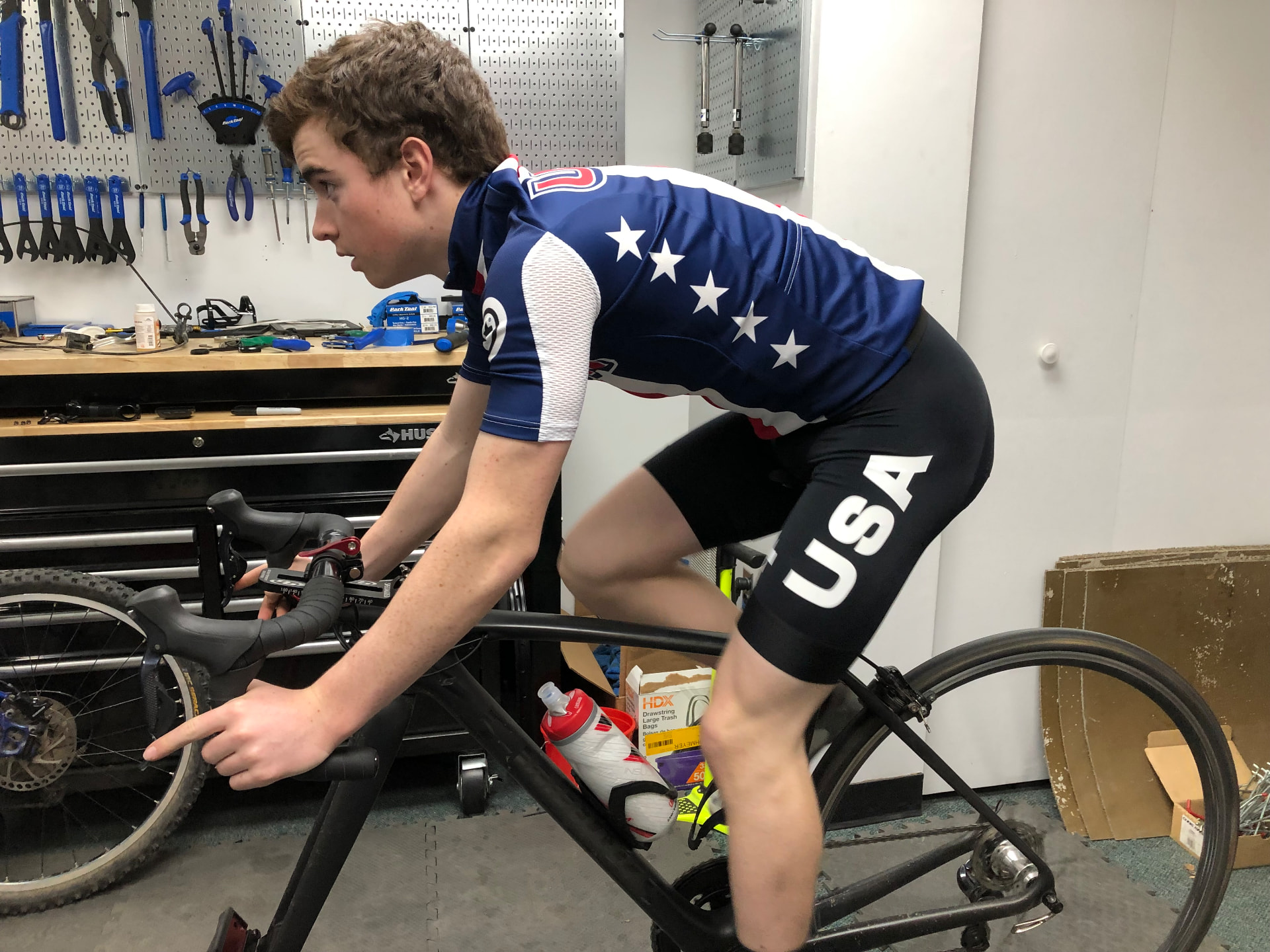Cyclist on a stationary trainer in a USA kit during a professional bike fitting session